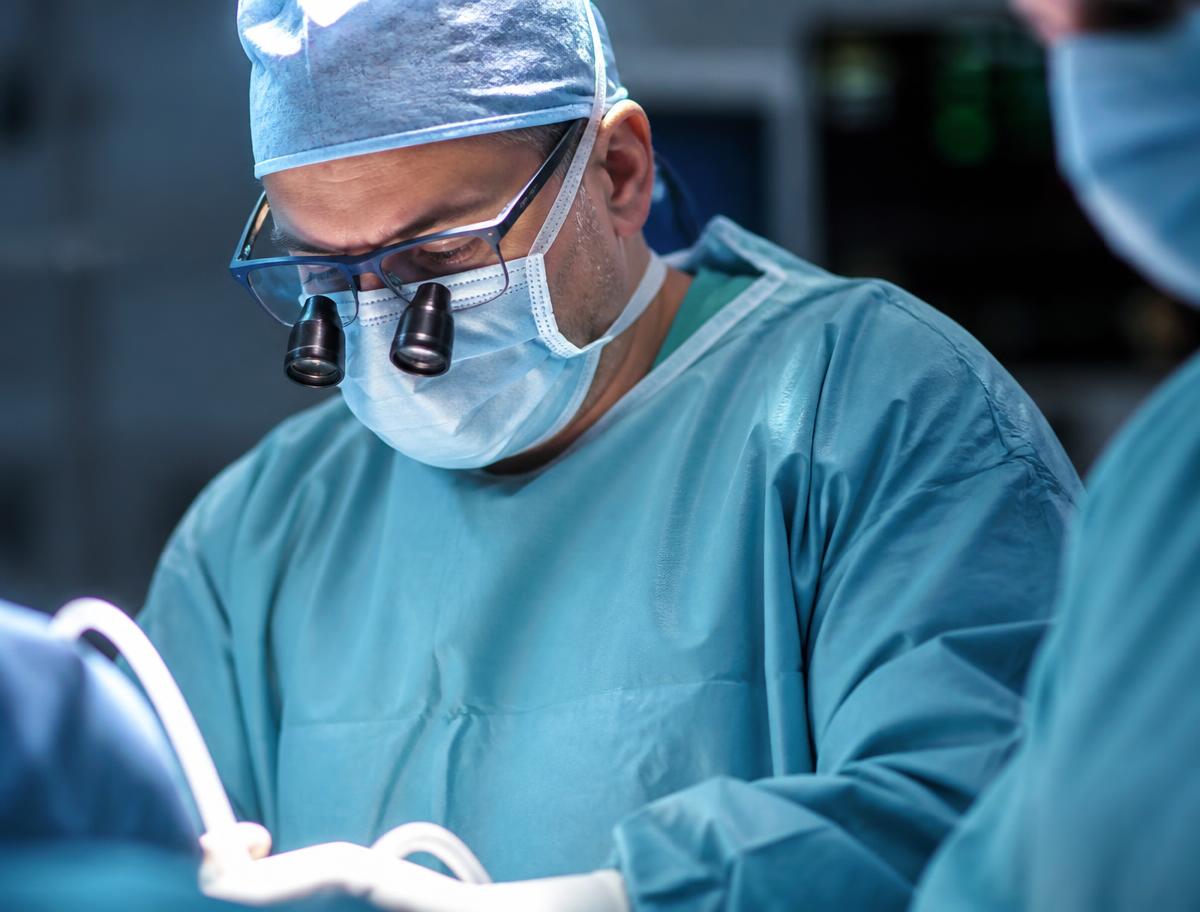 Cardiothoracic surgeon operating under theatre light at the Centre